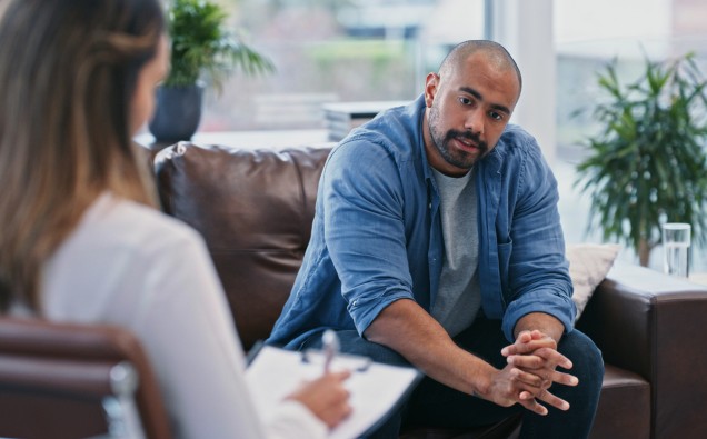 Cropped shot of a handsome young man looking thoughtful while sitting in session with his female therapist