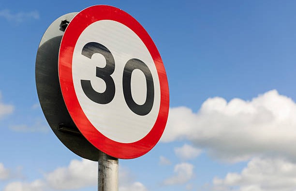 A British road sign for a 30 mile per hour speed limit area.