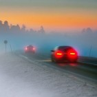 15039932 - rear lights of car on road in dark foggy winter evening