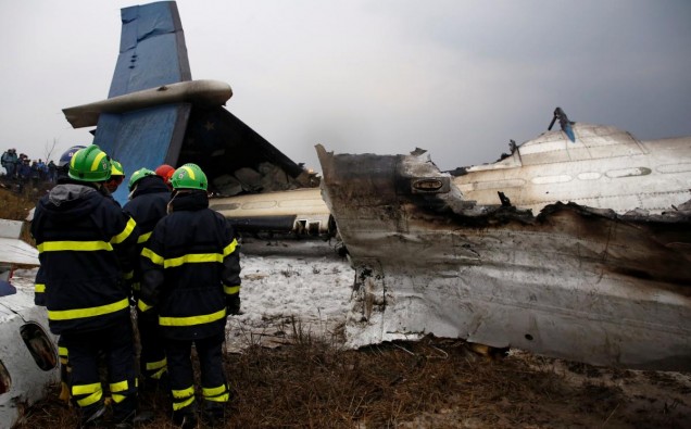 Rescue workers work at the wreckage of a US-Bangla airplane after it crashed at the Tribhuvan International Airport in Kathmandu