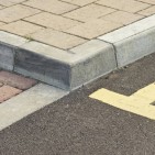 Tiled walkway in England, with double-yellow lines