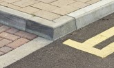 Tiled walkway in England, with double-yellow lines