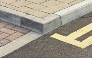 Tiled walkway in England, with double-yellow lines