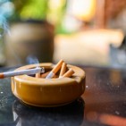 Cigarette burning with smoking on ceramic ashtray