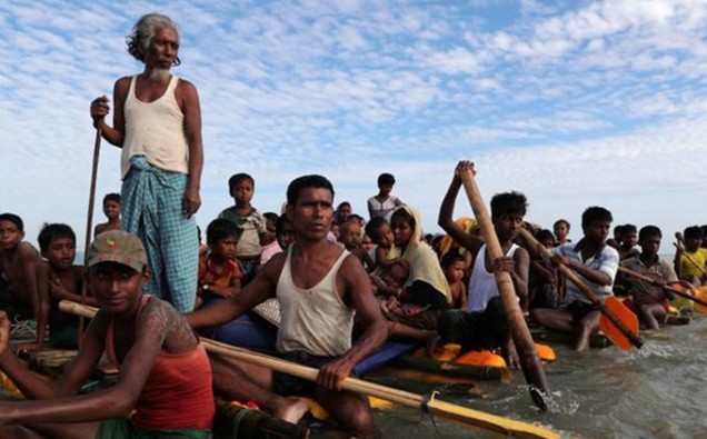 Rohingya refugees cross the Naf River with an improvised raft to reach to Bangladesh in Teknaf