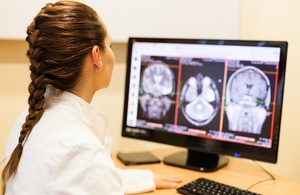 Female doctor analyzing MRI scan of the brain