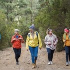 Multiracial women having fun during trekking day in to the wood - Focus on african woman face