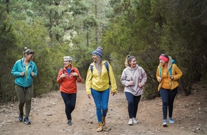 Multiracial women having fun during trekking day in to the wood - Focus on african woman face